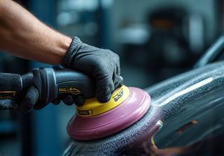 Technician carefully detailing a car's surface